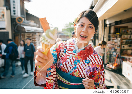 tourist trying famous matcha ice cream in Kyoto tourist trying famous matcha ice cream in Kyoto 45009197