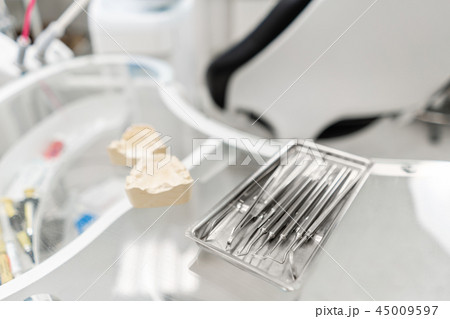Stomatological tools in the dentists clinic. Dental work in clinic. Operation, tooth replacement 45009597