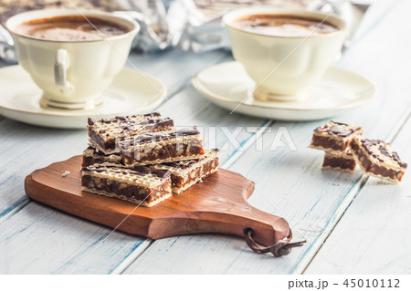 A waffle cake with caramel chocolate and walnuts. A waffle cake with caramel chocolate and walnuts. 45010112