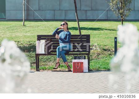 Beautiful girl with paper bags outside shopping mall 45010836