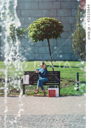 Beautiful girl with paper bags outside shopping mall Beautiful girl with paper bags outside shopping mall 45010844