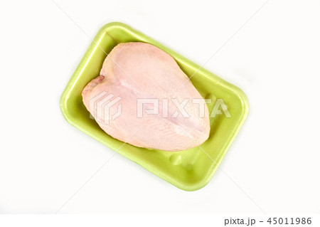 Raw chicken breast in a tray on a white background. 45011986