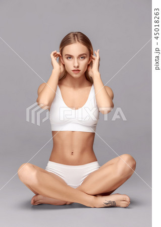 Happy young woman with slim and toned body Stock Photo by ©ianthraves  65050183