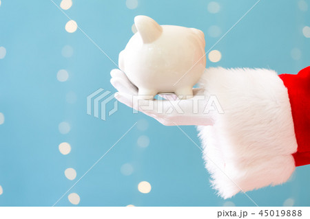 Santa holding a piggy bank Santa holding a piggy bank 45019888
