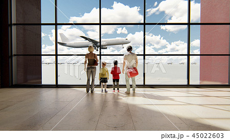 Happy family in airport near window looking on airplanes and waiting for time of flight at sunrise Happy family in airport near window looking on airplanes and waiting for time of flight at sunrise 45022603