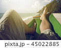 shot Man relaxing in the hammock set on the beach 45022885