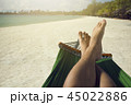 shot Man relaxing in the hammock set on the beach 45022886