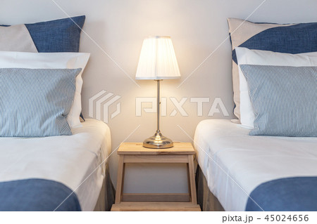 Modern bedroom with pillows and a bed for tourists. Frontally. 45024656