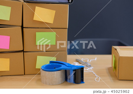 adhesive tape & parcel cardboard box. Online selling, e-commerce concept 45025902