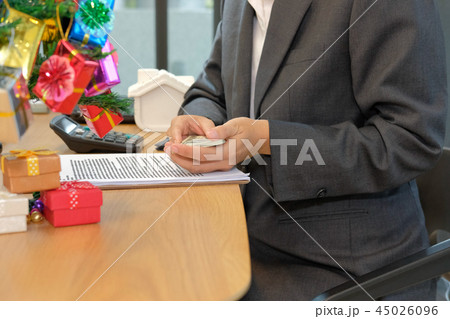 real estate agent with money banknote & mortgage loan contract agreement document during christmas 45026096