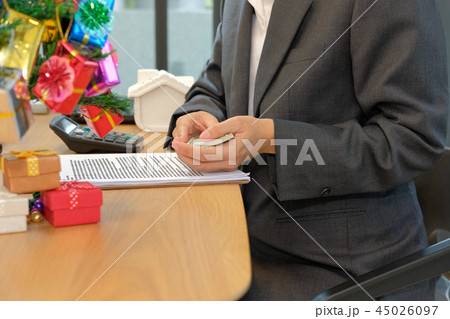 real estate agent with money banknote & mortgage loan contract agreement document during christmas real estate agent with money banknote & mortgage loan contract agreement document during christmas 45026097