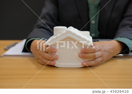 realtor agent presenting house model. buying selling renting real estate property 45026410