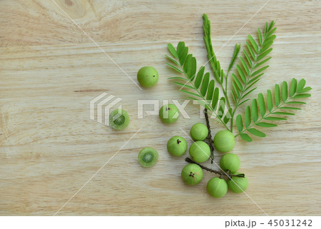Indian gooseberry on a wooden floor. Top view. 45031242