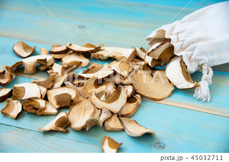 Dried mushrooms, on a blue wooden table 45032711