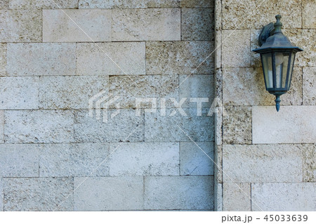 Stone wall with a lantern. Texture of a large gray 45033639
