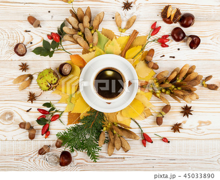 Mug of Coffee Surrounded By Leaves 45033890