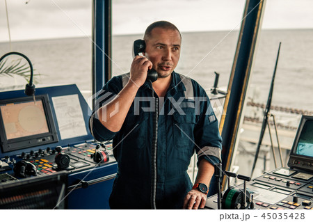 Marine navigational officer is reporting by VHF radio 45035428