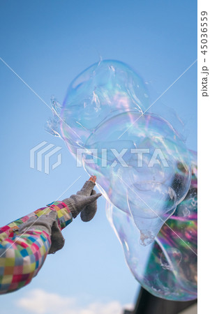 Girl reaching out to the soap bubble Girl reaching out to the soap bubble 45036559