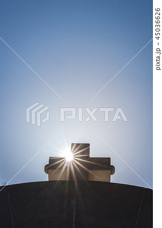 Cross on top of arched gates 45036626