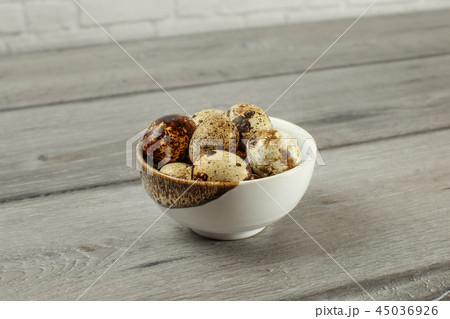 Spotted quail eggs in small porcelain bowl Spotted quail eggs in small porcelain bowl 45036926
