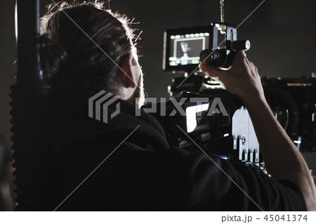 Professional videographer holding camera mounted on easy rig. Videographer using steadicam. Pro 45041374