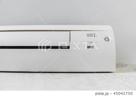 White air conditioner system on white wall in a room. White air conditioner system on white wall in a room. 45042750