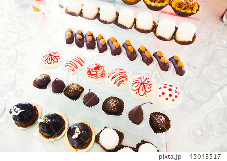 Delicious sweets on wedding candy buffet with desserts, cupcakes Delicious sweets on wedding candy buffet with desserts, cupcakes 45043517