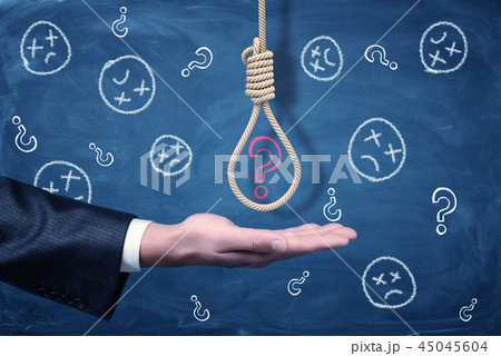 A businessman's hand with a hangman's noose above it with a red chalk question mark inside. 45045604