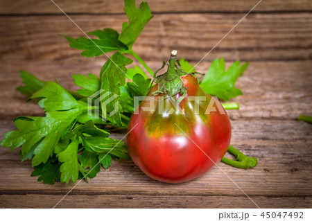 Tomato breed Wine Jug on wooden bachground Tomato breed Wine Jug on wooden bachground 45047492