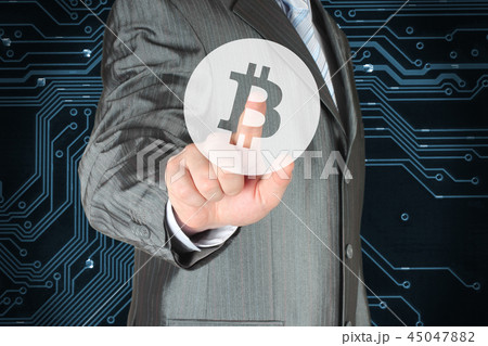 Businessman pushing button with Bitcoin symbol Businessman pushing button with Bitcoin symbol 45047882