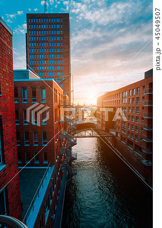 HafenCity. Bridge over canal and red brick buildings in the old warehouse district Speicherstadt in 45049507