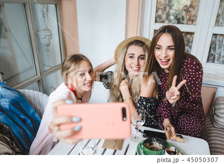 Three girls at the table Three girls at the table 45050307