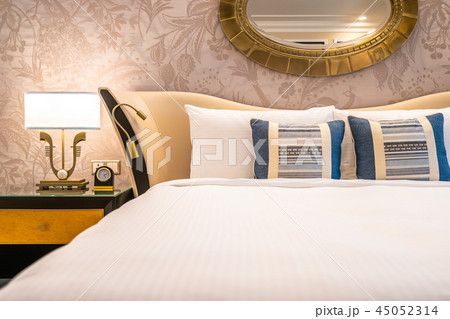 Comfotable pillow on bed with light lamp decoration Comfotable pillow on bed with light lamp decoration 45052314