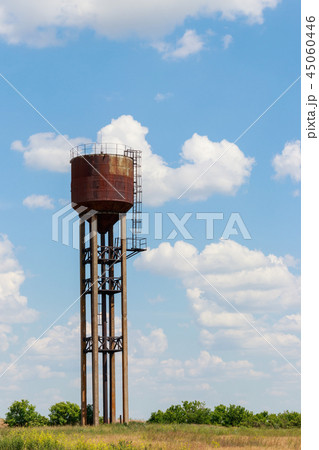 Old rusty water tower in the green field Old rusty water tower in the green field 45060446