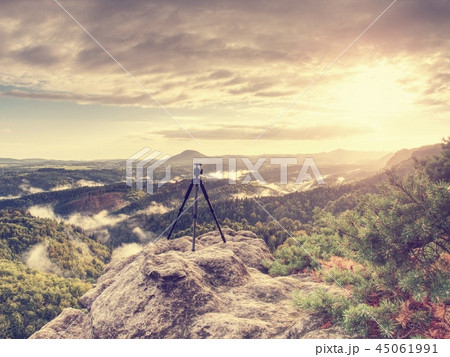 Mountain landscape with tripod in ready on edge. Mountain landscape with tripod in ready on edge. 45061991