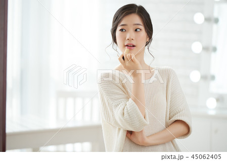 Applying lip balm Applying lip balm 45062405