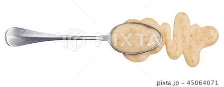 Sesame sauce. Splashes and spilled peanut sauce with spoon isolated on white background. Top view 45064071