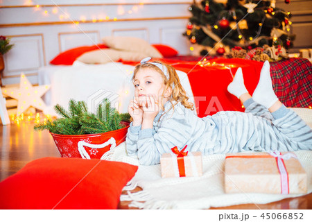Little girl in pajamas at Christmas morning Little girl in pajamas at Christmas morning 45066852