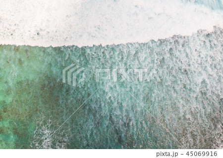 Aerial shot of the braking wave in the ocean. 45069916