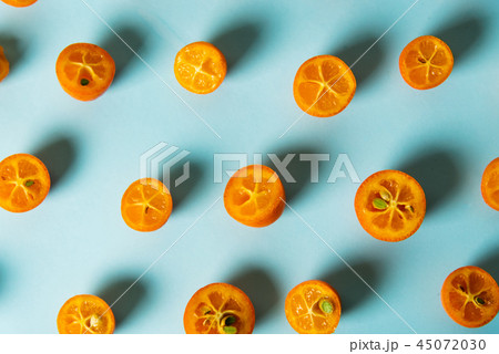 Kumquat fruit slices on blue background 45072030