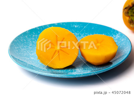 Persimmon kaki fruit on a plate isolated 45072048