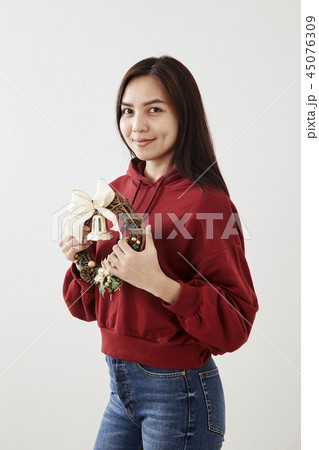 Girl holding Christmas wreath Girl holding Christmas wreath 45076309