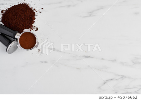 Coffee tamper and portafilter with ground coffee Coffee tamper and portafilter with ground coffee 45076662