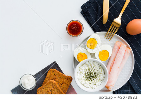 Healthy breakfast. Boiled eggs, ham and cheese Healthy breakfast. Boiled eggs, ham and cheese 45078833