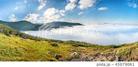 Panorama of green mountains in the clouds Panorama of green mountains in the clouds 45079061
