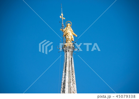 Golden Virgin Mary statue on top roof of Duomo 45079338