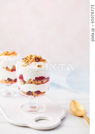 Healthy raspberry yogurt parfait in a glass 45079773