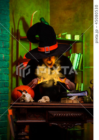 Image of witch of saucepans with magic potion 45080530