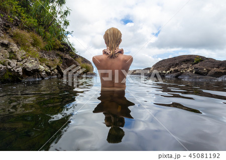 Naked woman bathing and relaxing in natural swimming pool. 45081192