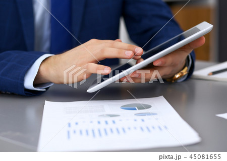 Businessman using touchpad at meeting, closeup of hands Businessman using touchpad at meeting, closeup of hands 45081655